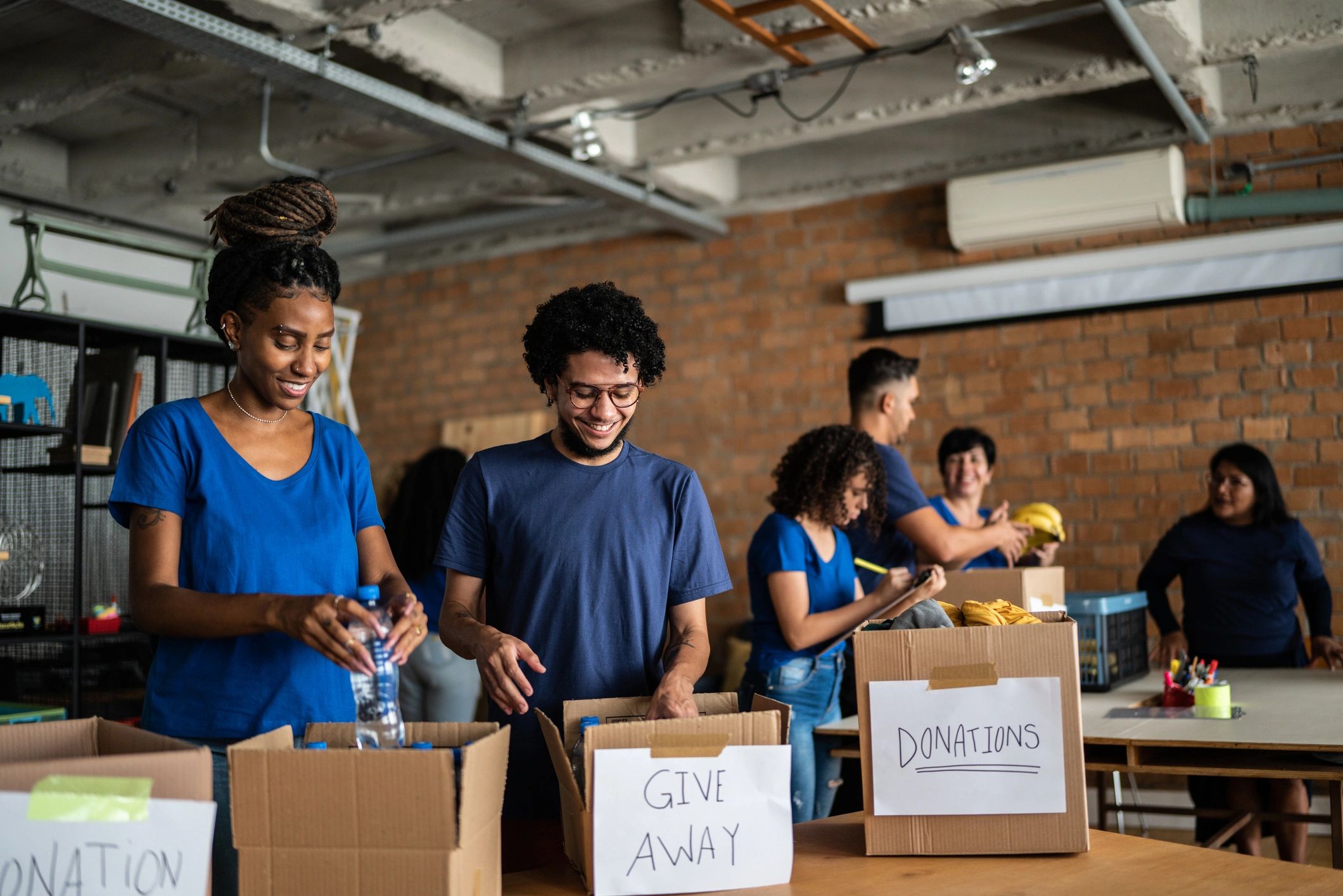 Youth volunteers organizing donations, representing giveback