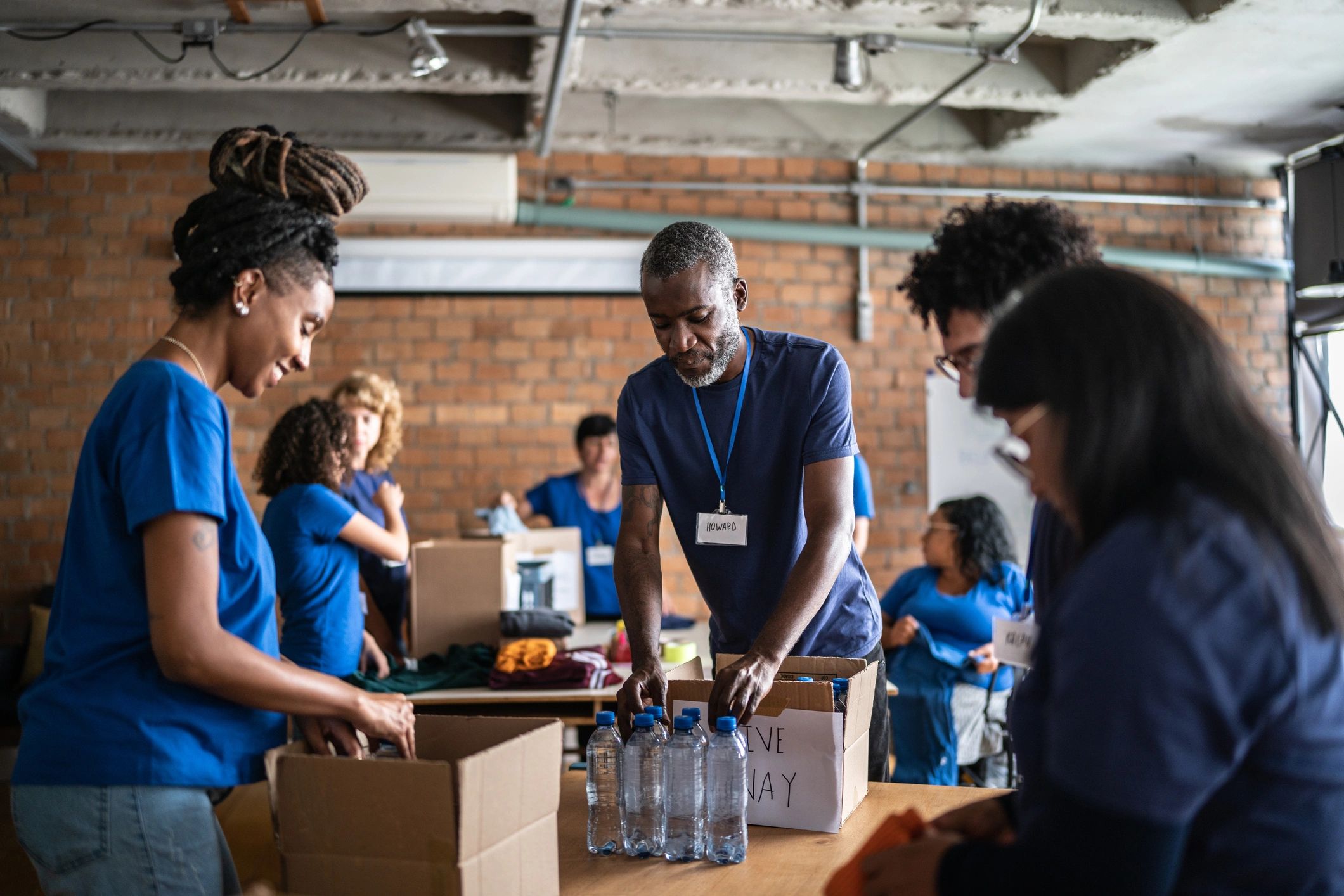Volunteers arranging donations in a charity donation center
