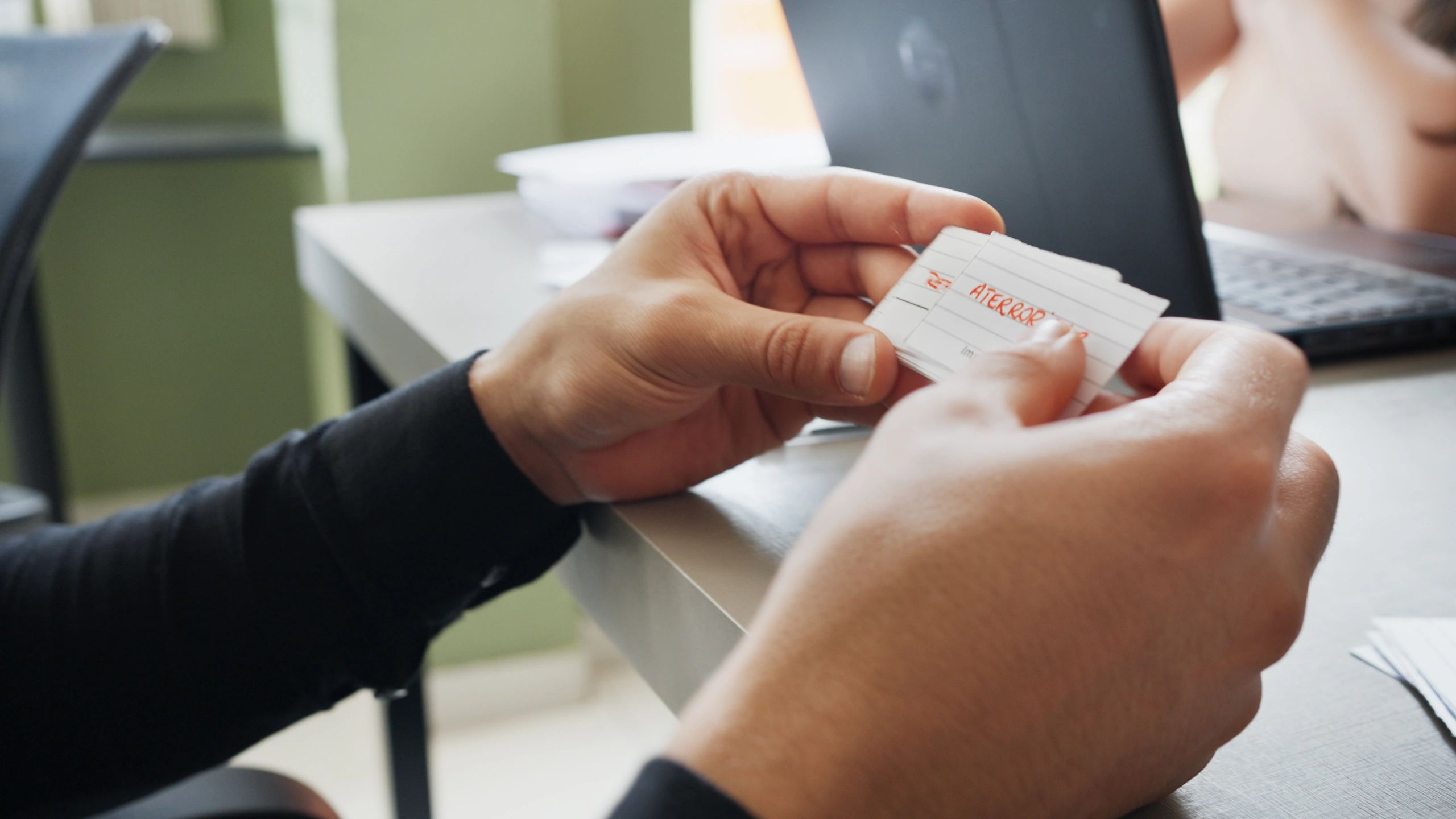 Person holding a card, representing collecting and learning