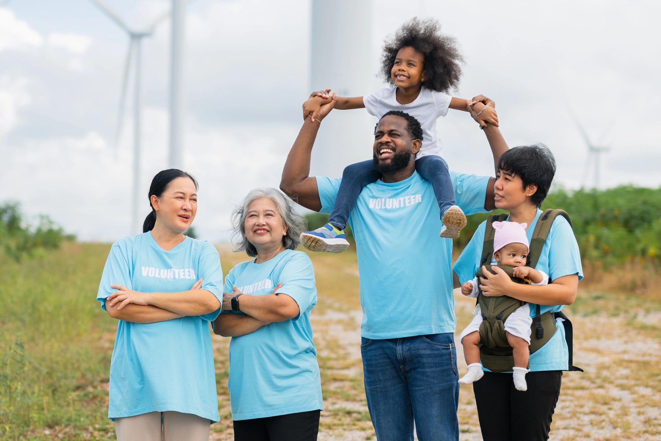 Group of volunteers wearing shirts and smiling together