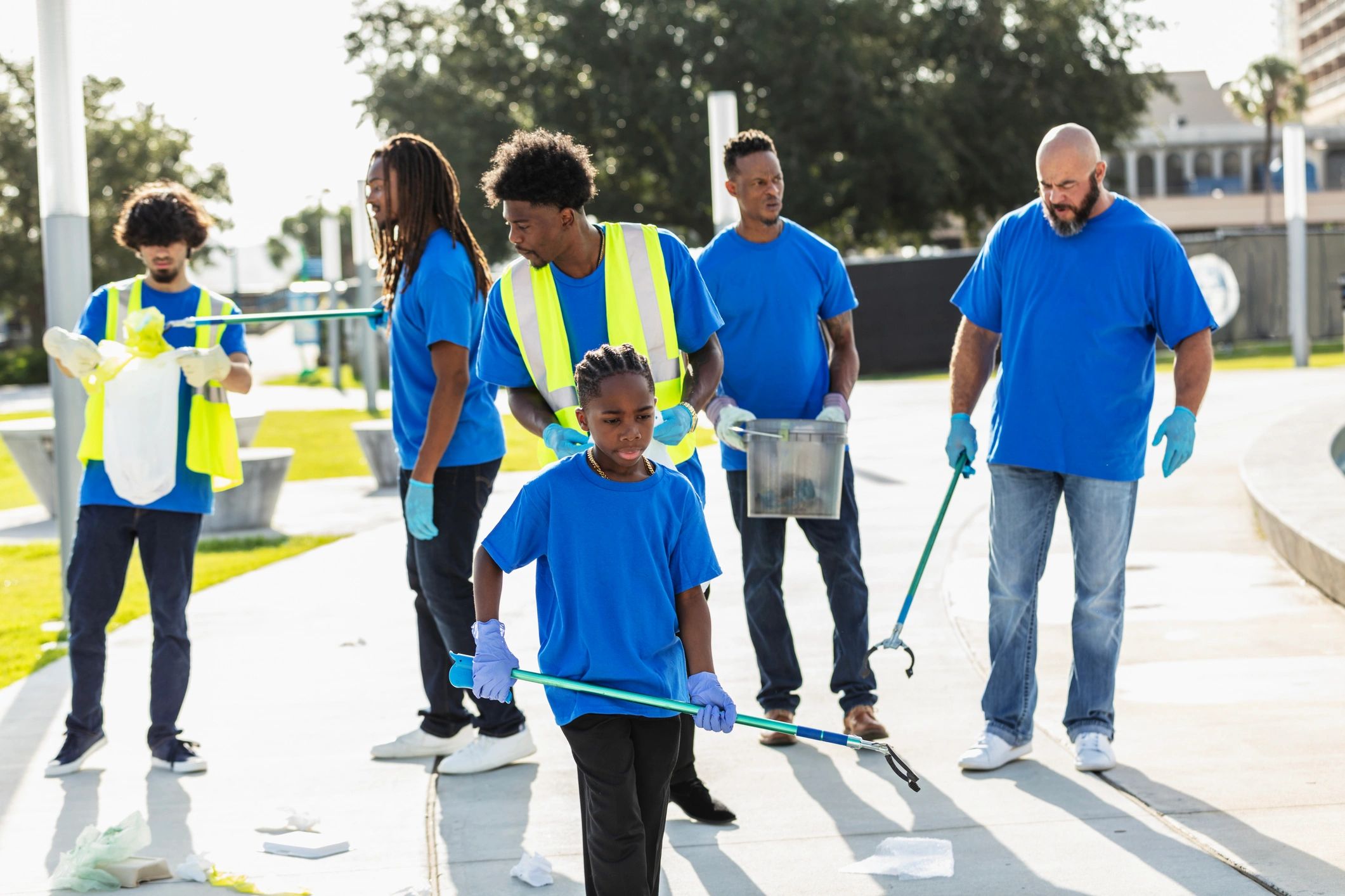Volunteers picking up litter in a park